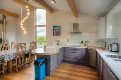 a kitchen with a counter and a table in it at House 42 in Looe