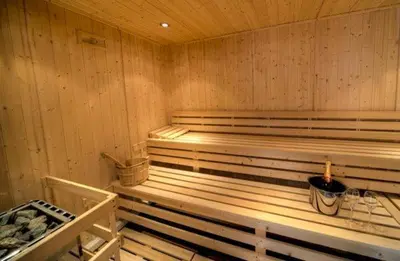 a sauna with wooden walls and a bench in it at House 42 in Looe