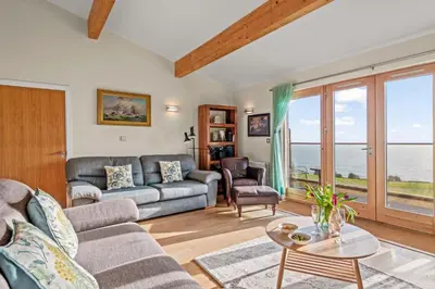 a living room with a couch and a table at House 42 in Looe