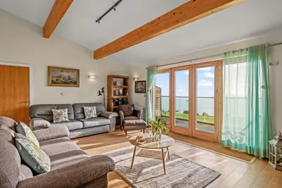 a living room with a couch and a table at House 42 in Looe