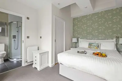 a bedroom with a bed with a bowl of fruit on it at House 9 in Looe