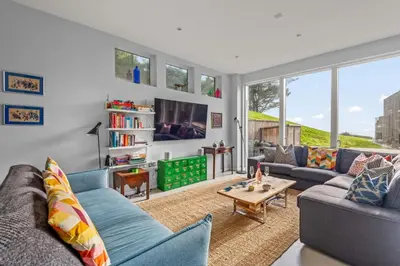 a living room with a couch and a table at House 46 in Looe