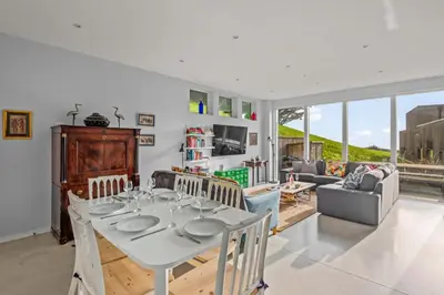 a living room with a white table and chairs at House 46 in Looe