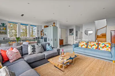 a living room with a couch and a table at House 46 in Looe