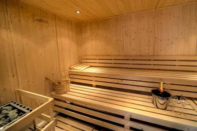 a wooden sauna with a bucket in it at House 7 in Looe
