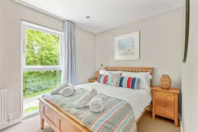 a bedroom with a bed with towels on it at House 7 in Looe