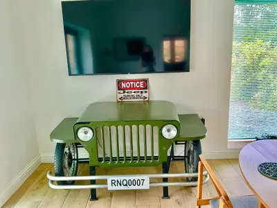 a table with a green jeep in a room at The Jeep House in the Area of Outstanding Natural Beauty in Liskeard