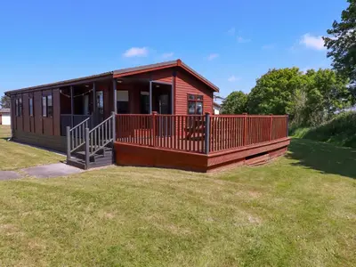 a small house with a large deck on a yard at Lodge 9 - Lamorna in Padstow