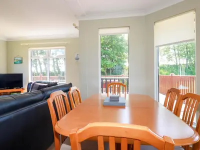 a living room with a table and a couch at Lodge 9 - Lamorna in Padstow