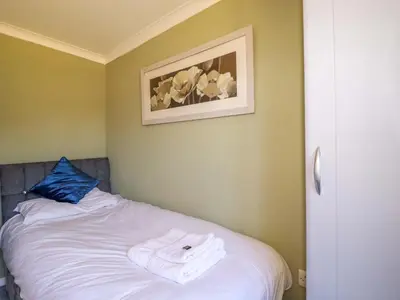 a room with a bed with a towel on it at Lodge 9 - Lamorna in Padstow