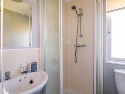 a bathroom with a shower and a sink at Lodge 9 - Lamorna in Padstow