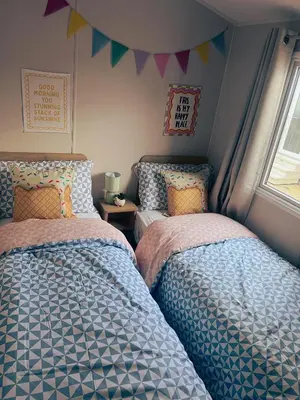 two beds sitting next to each other in a bedroom at Sandy Nights in Tywardreath