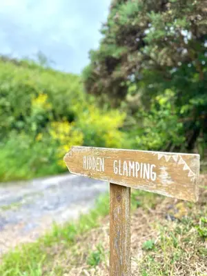 a wooden sign for a lincoln gambling at Luxury Shepherds Hut With Wood Fired Hot Tub in Mawgan Porth
