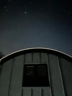 a view of the night sky from the top of a building at Luxury Shepherds Hut With Wood Fired Hot Tub in Mawgan Porth