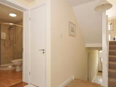 a bathroom with a toilet and a shower at 9 Slipway Cottages in Wadebridge