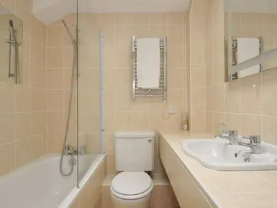 a bathroom with a toilet and a sink and a shower at 9 Slipway Cottages in Wadebridge