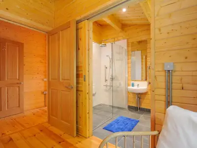 a bathroom with a shower and a sink at Owl Lodge in Liskeard