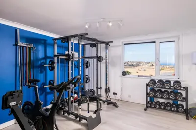 a gym with cardio equipment and a window at Blue Mist Studio in St Ives