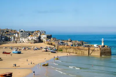 a group of people on a beach near the ocean at Blue Mist Studio in St Ives