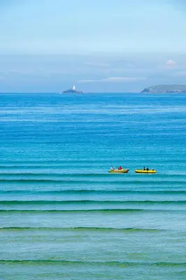 two boats floating on the water in the ocean at Blue Mist Studio in St Ives