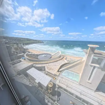 a view of the ocean from the balcony of a resort at Tate Five Penthouse apartment with panoramic views of St Ives in St Ives