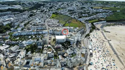an aerial view of a city with a beach at Tate Five Penthouse apartment with panoramic views of St Ives in St Ives