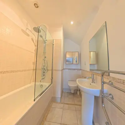 a bathroom with a sink and a shower and a toilet at Tate Five Penthouse apartment with panoramic views of St Ives in St Ives