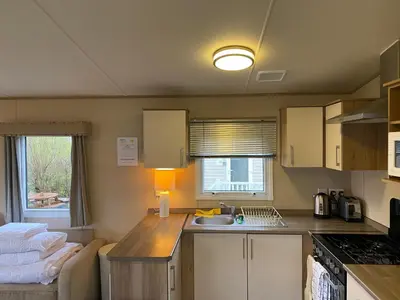a small kitchen with a counter and a sink at Cornish Caravan Escapes in Porth