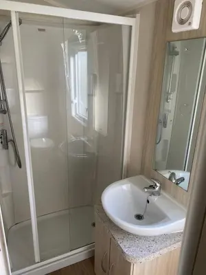 a bathroom with a shower and a sink at Cornish Caravan Escapes in Porth