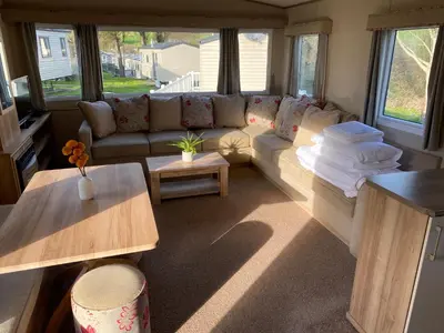 a living room with a couch and a table at Cornish Caravan Escapes in Porth