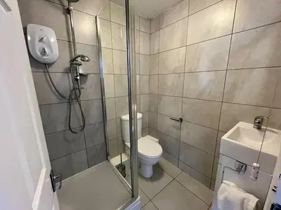 a bathroom with a shower and a toilet at Sea view Studio by Fistral Beach in Newquay