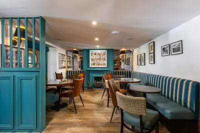 a restaurant with tables and chairs in a room at Basset Arms, Portreath, Cornwall in Portreath