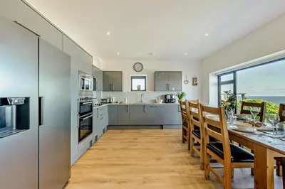 a kitchen and dining room with a table and chairs at 4 Bed in St. Ives oc-c28788 in St Ives