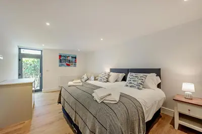 a bedroom with a large bed and a window at 4 Bed in St. Ives oc-c28788 in St Ives