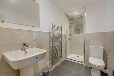 a bathroom with a sink and a toilet and a shower at 4 Bed in St. Ives oc-c28788 in St Ives