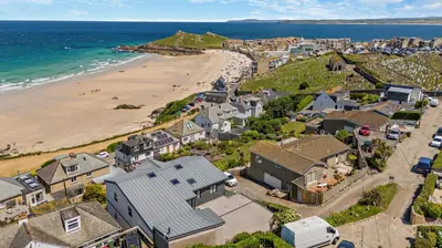 an aerial view of a beach with houses and the ocean at 4 Bed in St. Ives oc-c28788 in St Ives