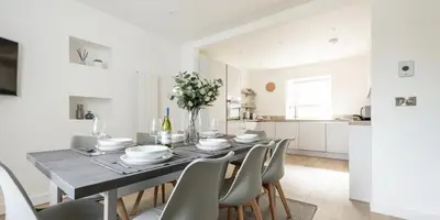 a kitchen and dining room with a table and chairs at VITAMYN SEA, 4 bedroom house, Sleeps 8, 6 beds, Sea views, 5 min walk to harbour and beaches in St Ives