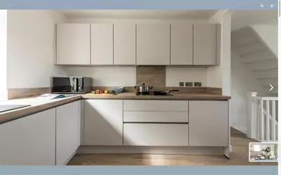 a kitchen with white cabinets and a counter top at VITAMYN SEA, 4 bedroom house, Sleeps 8, 6 beds, Sea views, 5 min walk to harbour and beaches in St Ives