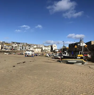 a group of boats parked on the beach at VITAMYN SEA, 4 bedroom house, Sleeps 8, 6 beds, Sea views, 5 min walk to harbour and beaches in St Ives