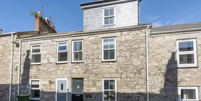 an old stone house with a tower on top at VITAMYN SEA, 4 bedroom house, Sleeps 8, 6 beds, Sea views, 5 min walk to harbour and beaches in St Ives