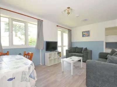 a living room with a couch and a table at 4 Rosecraddoc Lodge Holiday Bungalows in Liskeard