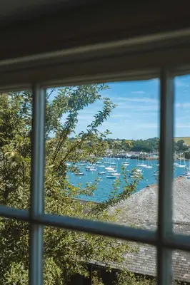 a view of a harbor through a window at Merthen House in Falmouth