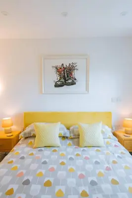 a bedroom with a bed with two pillows at Merthen House in Falmouth