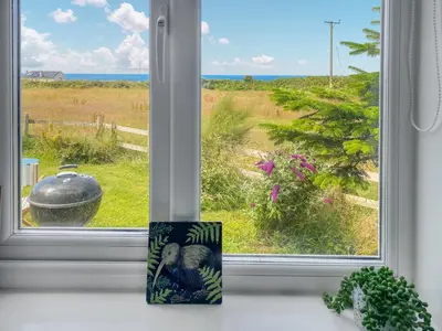 a window with a view of the ocean at Gwennel Nook in St. Agnes