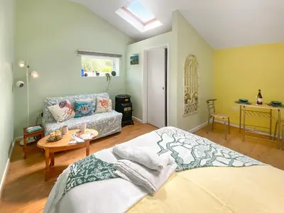 a bedroom with a bed and a table and a couch at Gwennel Nook in St. Agnes