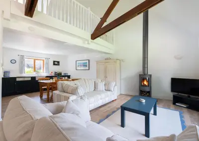 a living room with a couch and a fireplace at Idle Rock in Polzeath