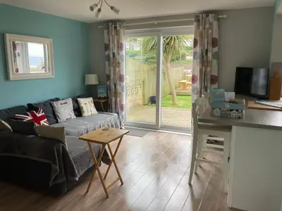 a living room with a couch and a table at 'The Dunes', Porthtowan in Porthtowan