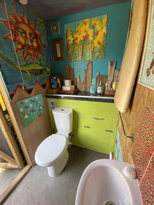 a bathroom with a white toilet and a sink at Quiet peaceful relaxing off grid Campervan Seaview and Ponies in Carbis Bay
