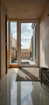 an empty room with a large glass door with a view at Shorebreak Apartment 2 in Newquay