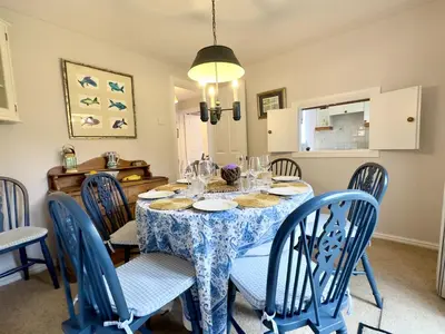 a dining room with a blue table and chairs at Choughs in Saint Minver